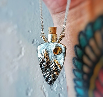 Fantasy inspired tiny corked sterling silver potion bottle featuring mountains and a sparkling Citrine sun.