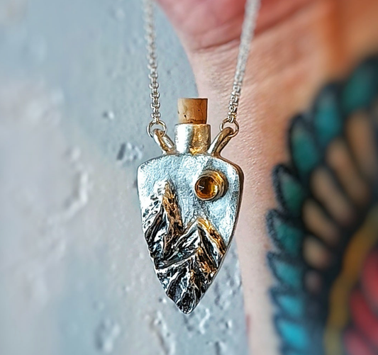 Fantasy inspired tiny corked sterling silver potion bottle featuring mountains and a sparkling Citrine sun.