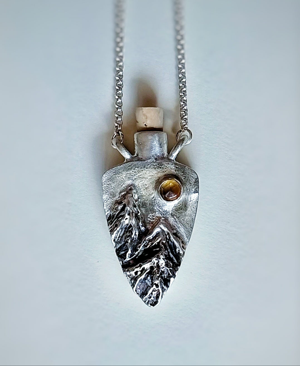 Fantasy inspired tiny corked sterling silver potion bottle featuring mountains and a sparkling Citrine sun.
