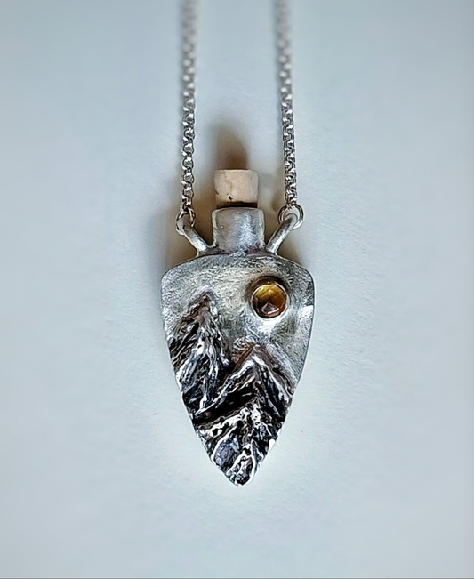 Fantasy inspired tiny corked sterling silver potion bottle featuring mountains and a sparkling Citrine sun.